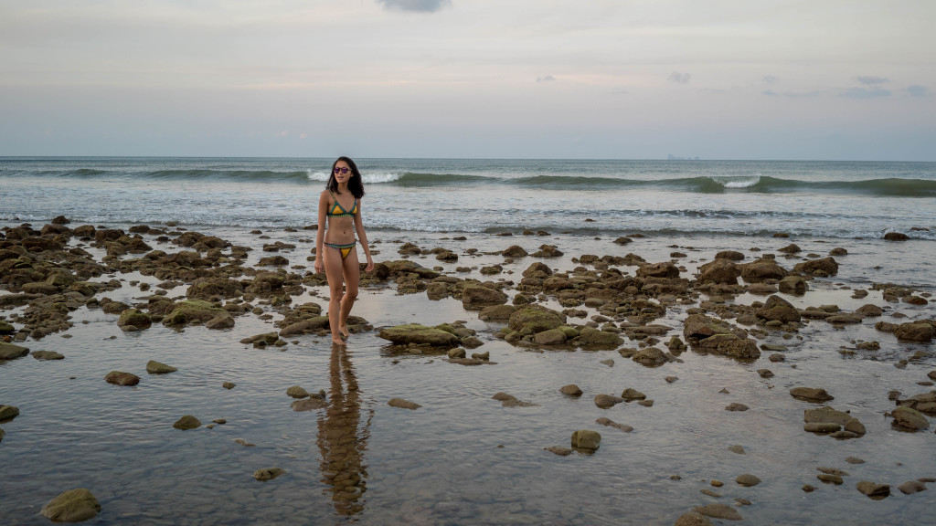 woman at the beach wearing a two piece swimsuit