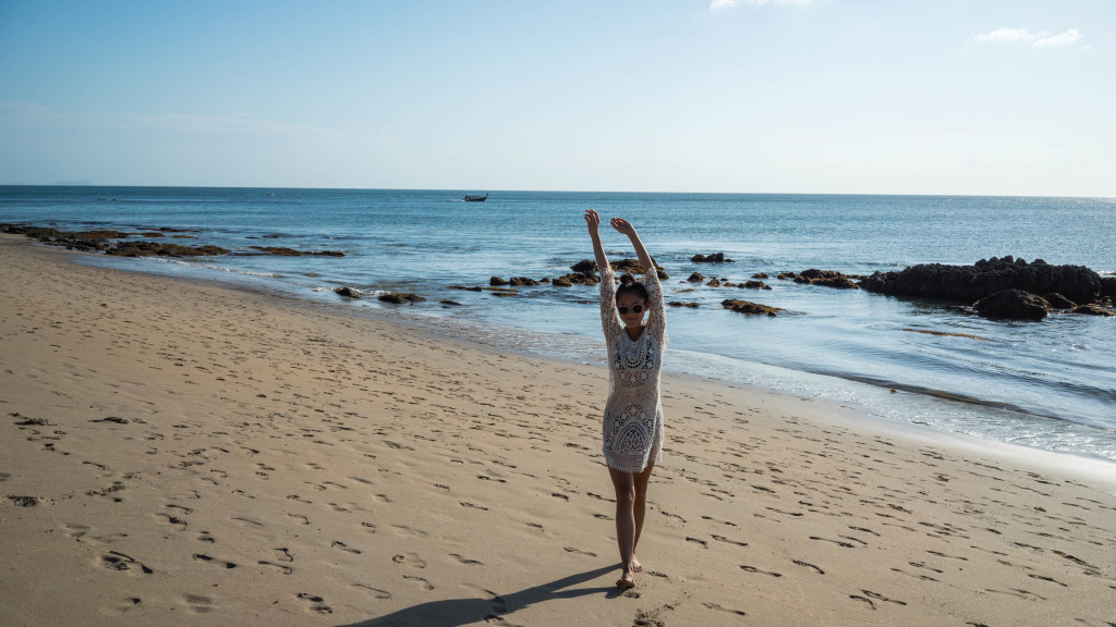 woman at the beach wearing crocheted cover up