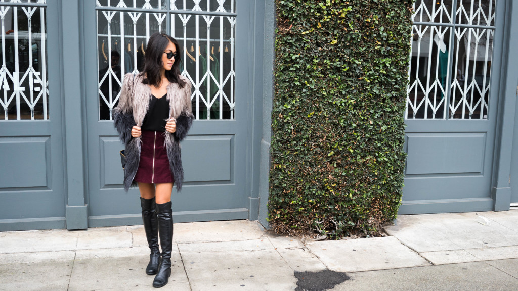 woman wearing Ombre fur coat, skirt, and black top