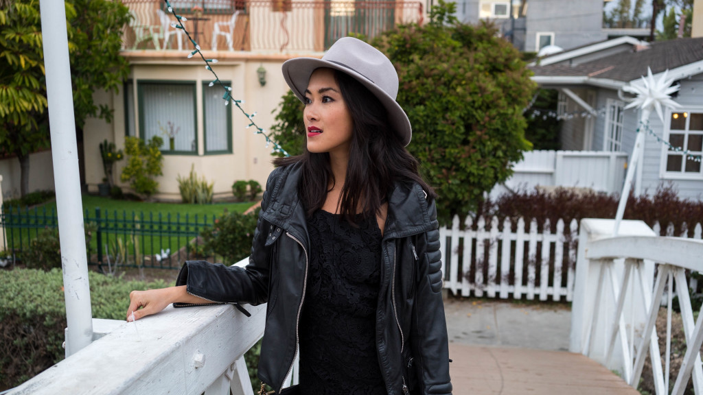 woman wearing black romper and fedora hat for Venice