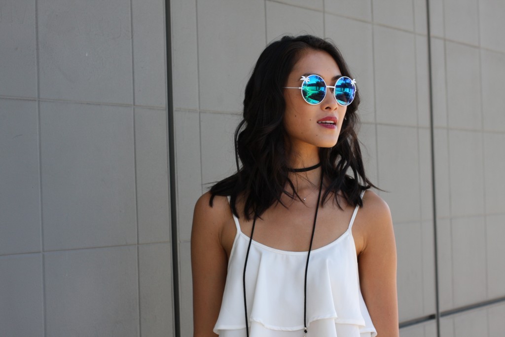 woman wearing white top and Quay Sunglasses