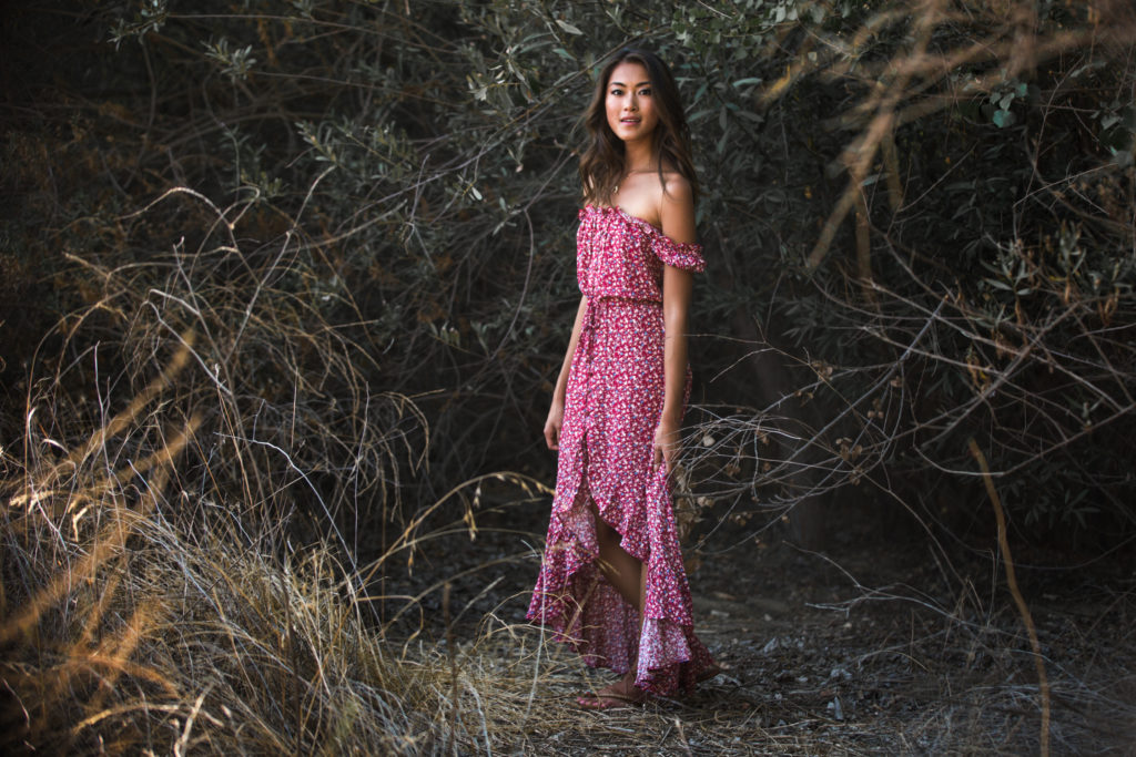 woman smiling and wearing off shoulder maxi dress