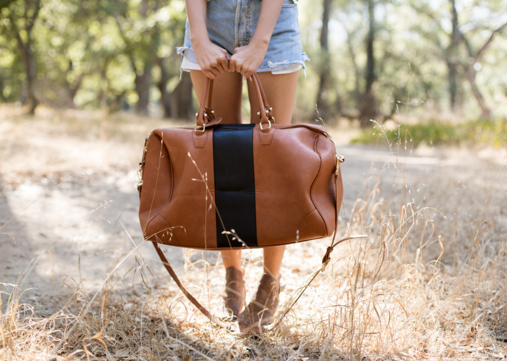woman wearing a brown leather bag