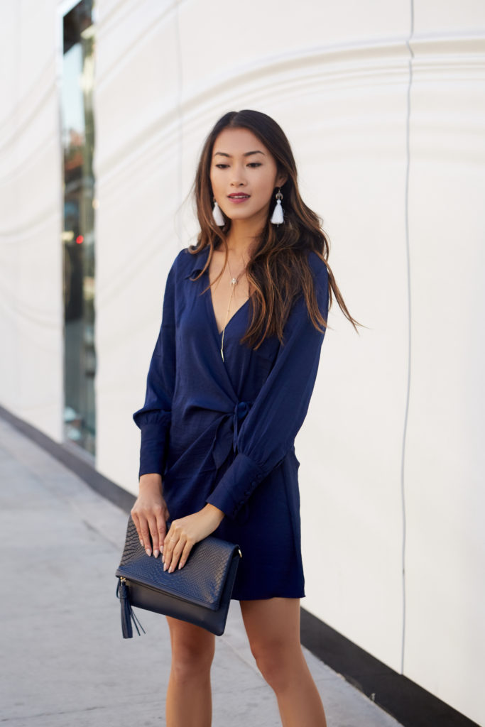 woman in blue dress and black clutch