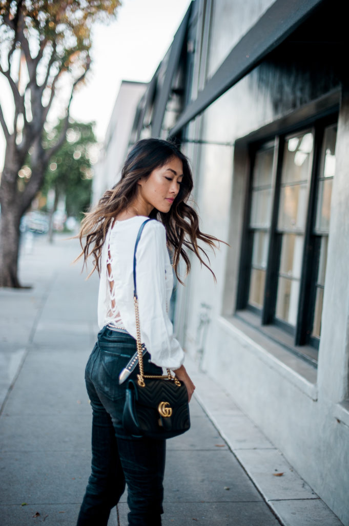 woman wearing white top, jeans, and fall style restricted shoes 