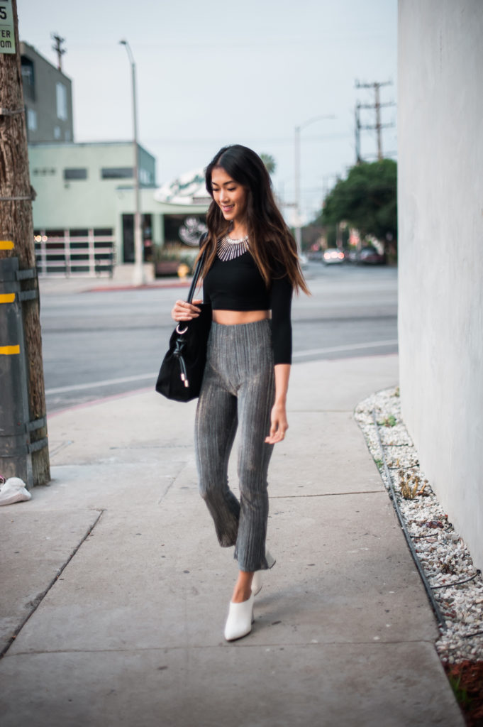 woman walking and wearing Party Pants and black top