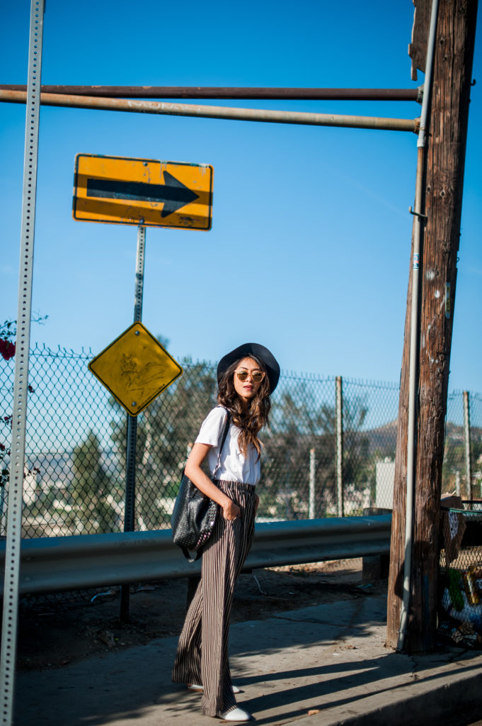 woman sharing her thoughtful wardrobe and wearing shirt and wide pants