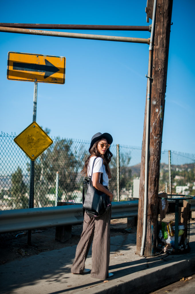 woman standing near a street sign