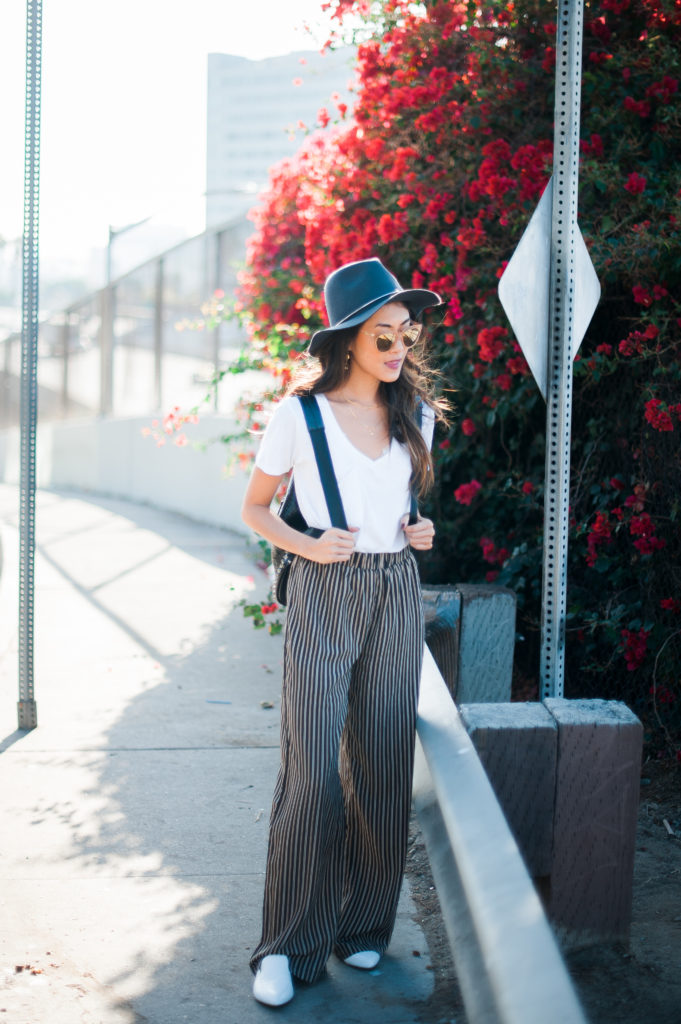 woman wearing white shirt and wide pants for a thoughtful wardrobe