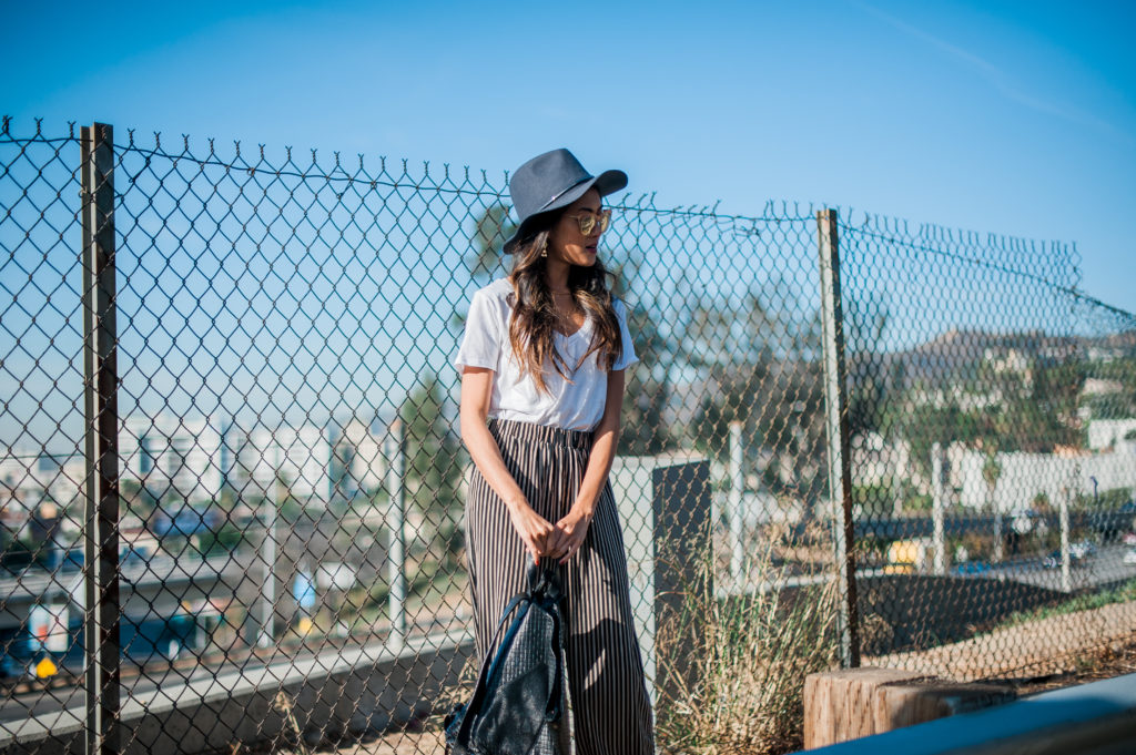 woman leaning on a wire fence 