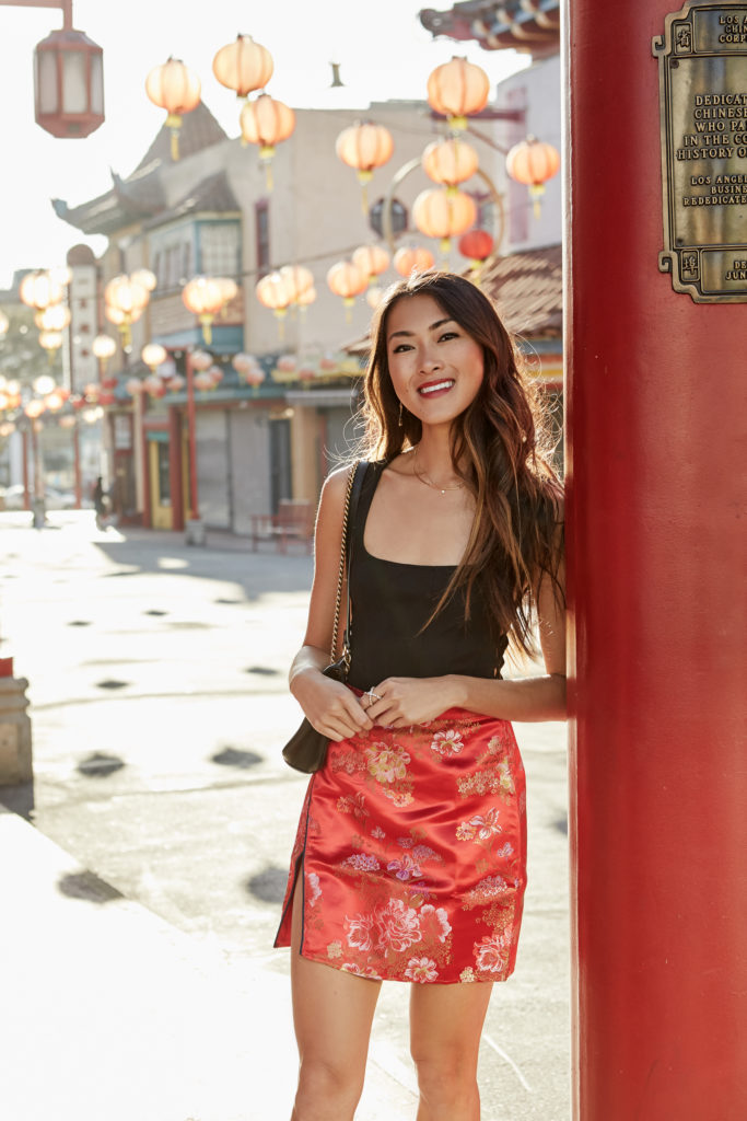 woman wearing black and top red skirt for celebrating Year of the Dog - Chinese New Year