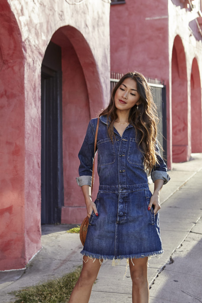 woman wearing dress in denim and hands on her pocket