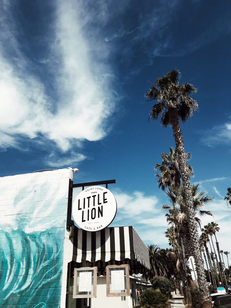 little lion cafe and bar signage and palm trees 