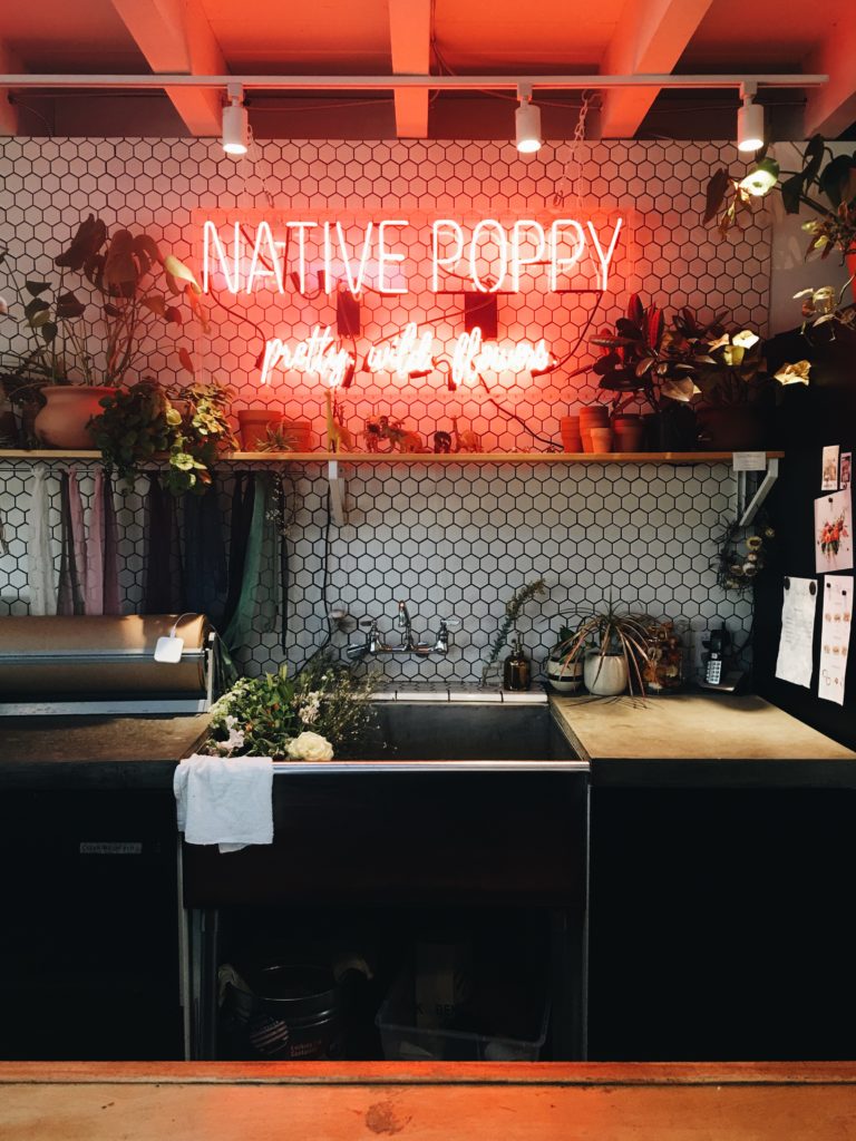 native poppy neon sign on top of a sink for 72 Hours in San Diego