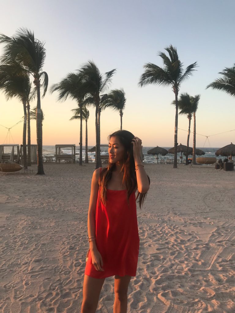 woman at the beach wearing red dress