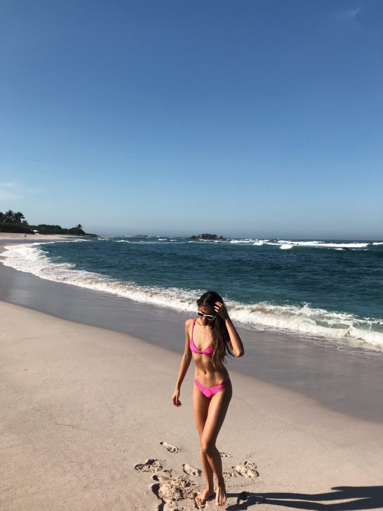 woman in pink two piece at the beach