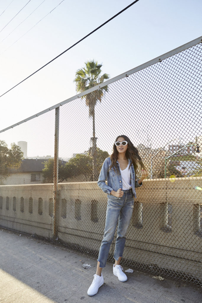 woman flipping hair and wearing denim jeans and jacket for Spring Denim Update