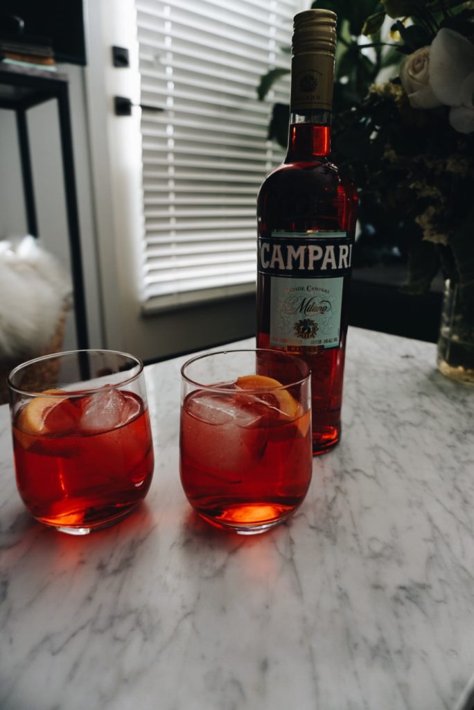 two glasses and a bottle of Cocktails with Campari