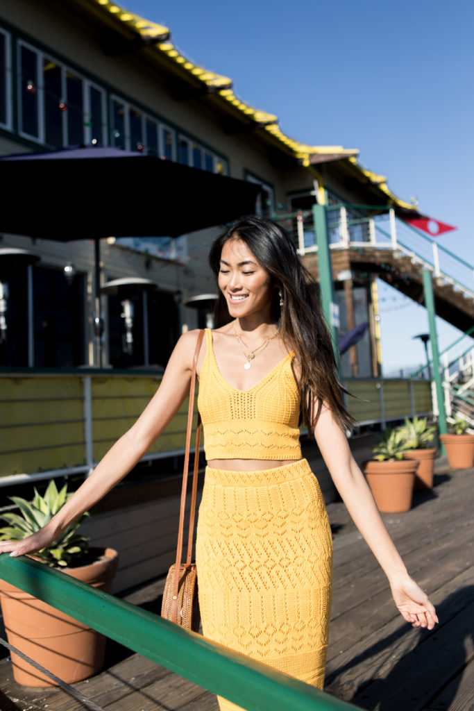 woman standing in yellow skirt and top learning to Love the Crop Top 