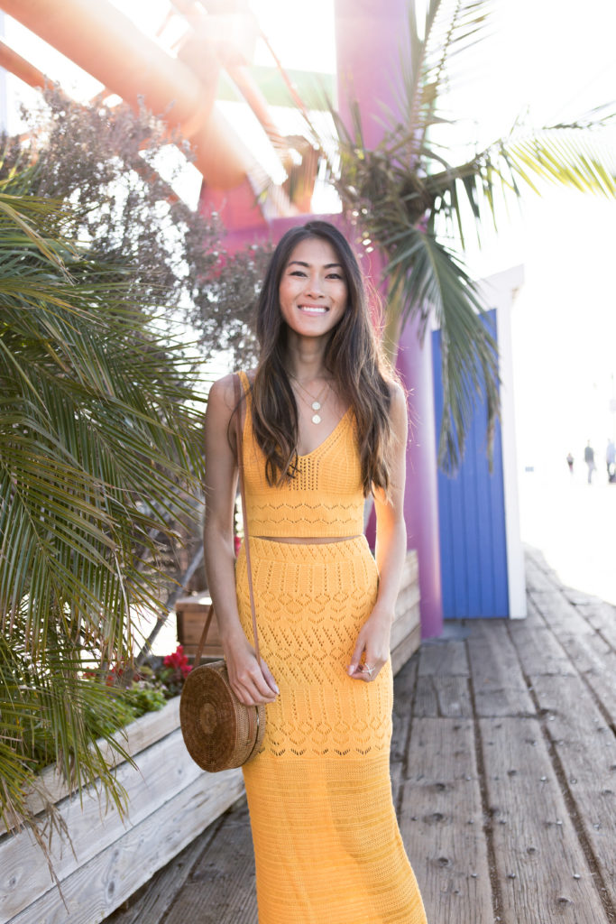 woman smiling and wearing yellow skirt and top