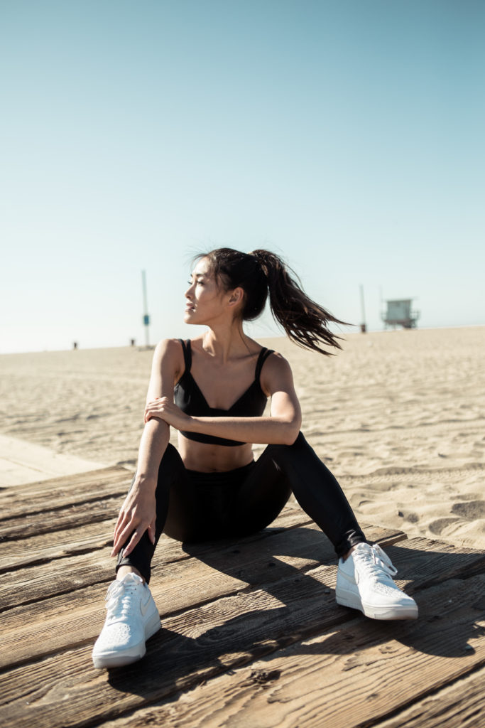 woman sitting down and resting after a workout