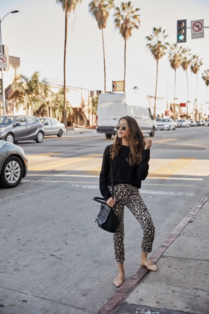 How to Build a Wardrobe with black sweater and animal print jeans