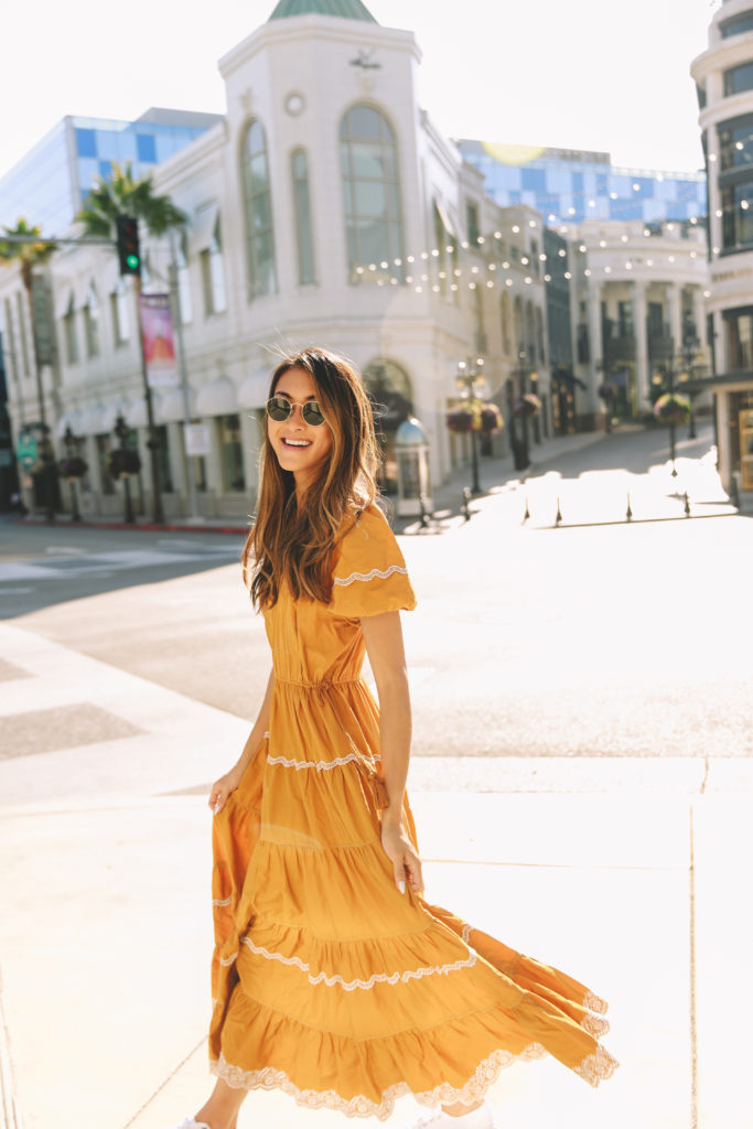 this girl in a yellow dress is teaching how you can reduce your carbon footprint as an influencer