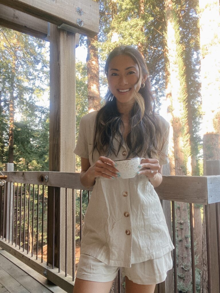 woman in the outdoors holding a cup